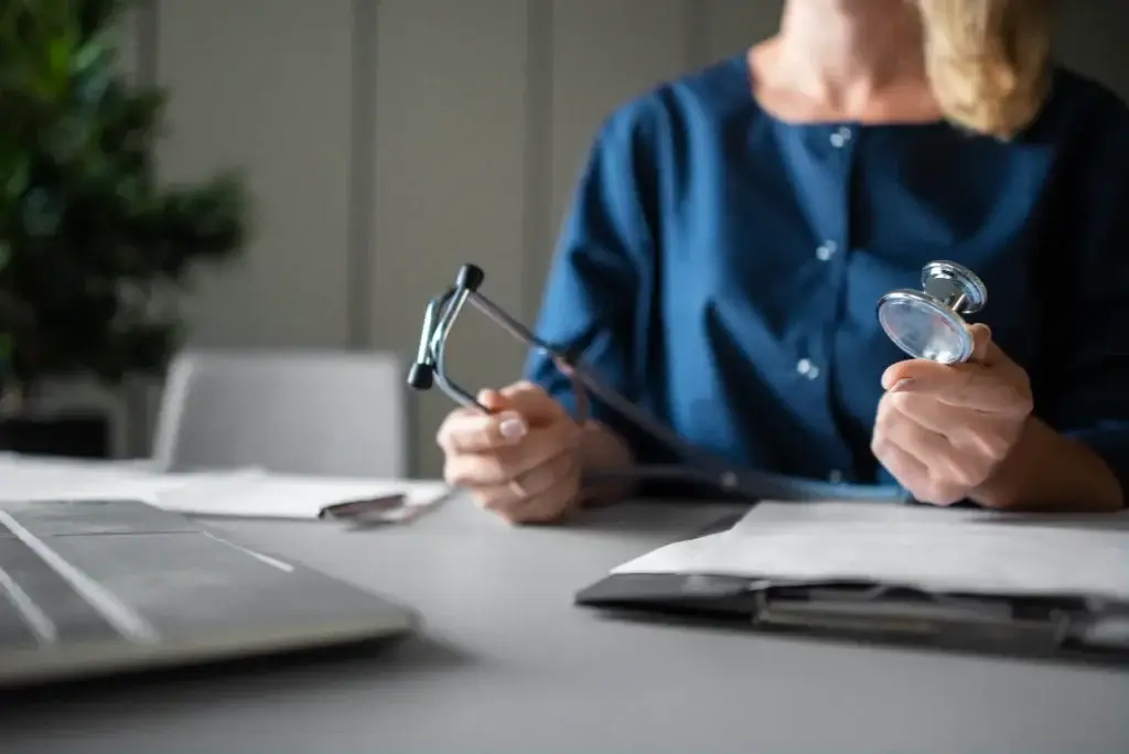 Nurse holding a stethoscope and medical documents, emphasizing personalized healthcare and concierge services.